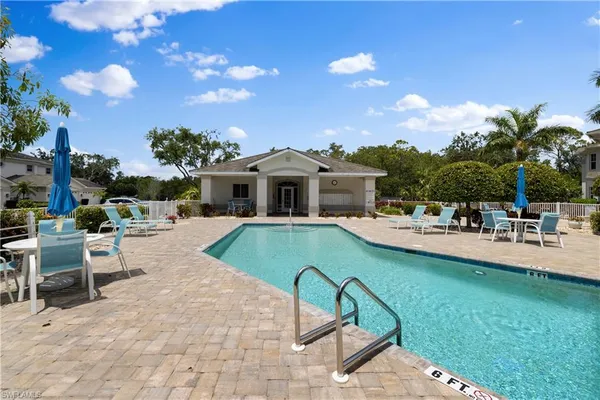 a view of a house with swimming pool and sitting area