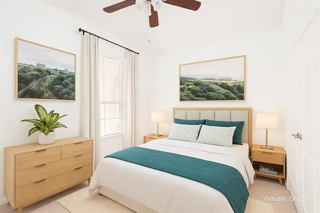 a bedroom with a bed potted plant on the dresser and a window