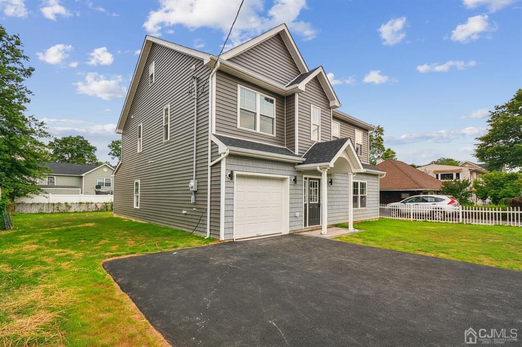 109 Idlewild Road Edison, NJ 08817 - Photo 1 of 15 a front view of a house with a yard and garage
