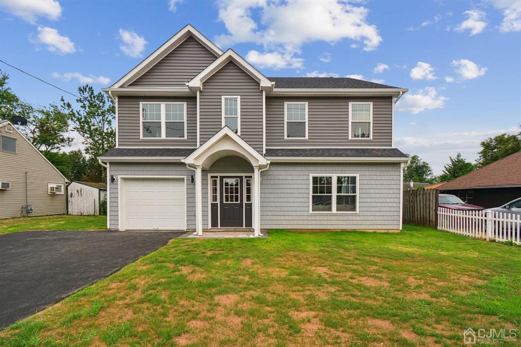 109 Idlewild Road Edison, NJ 08817 - Photo 2 of 15 a front view of a house with a yard and garage
