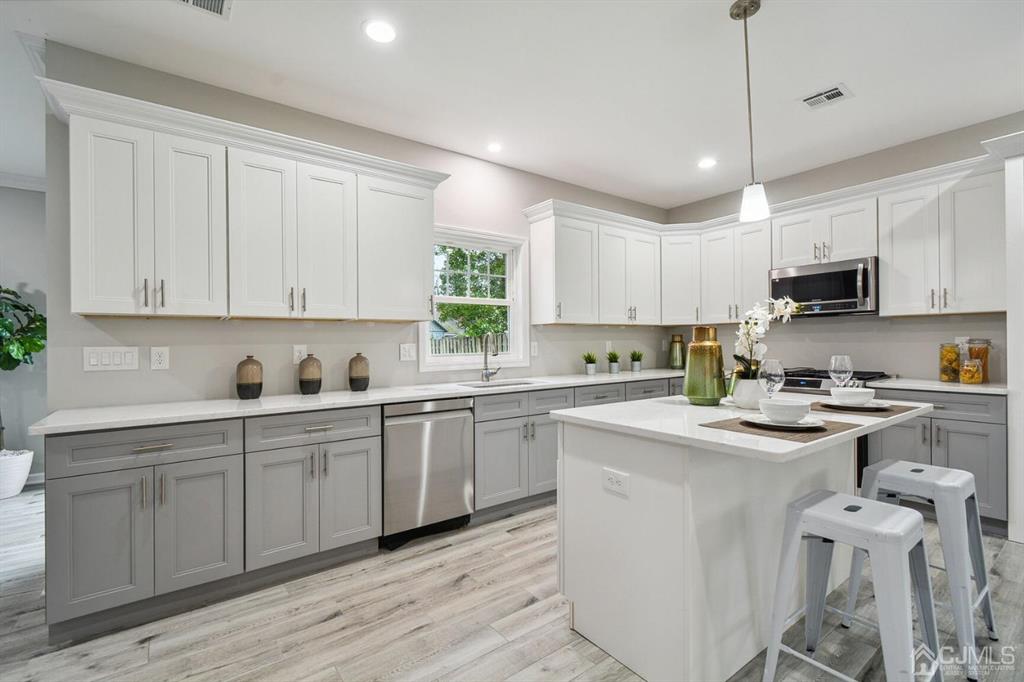 109 Idlewild Road Edison, NJ 08817 - Photo 5 of 15 a kitchen with a sink white cabinets and white appliances