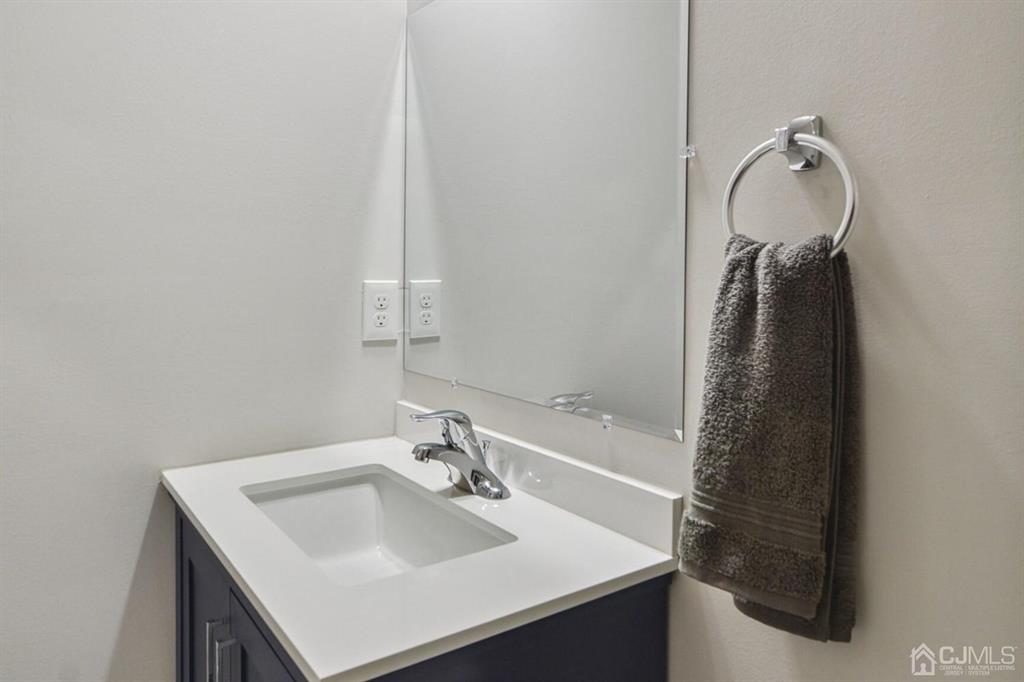 109 Idlewild Road Edison, NJ 08817 - Photo 9 of 15 a bathroom with a sink and a mirror