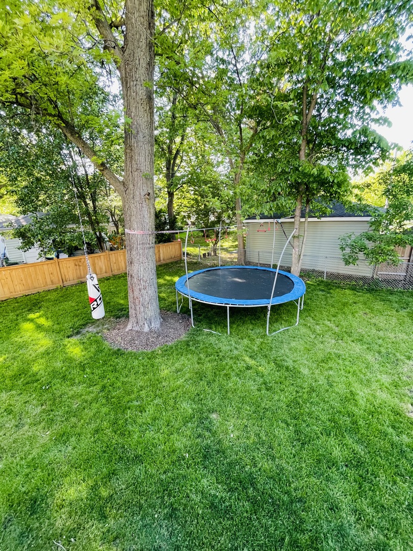 1565 Harding Road Northfield, IL 60093 - Photo 27 of 35 a backyard of a house with wooden deck and a bench
