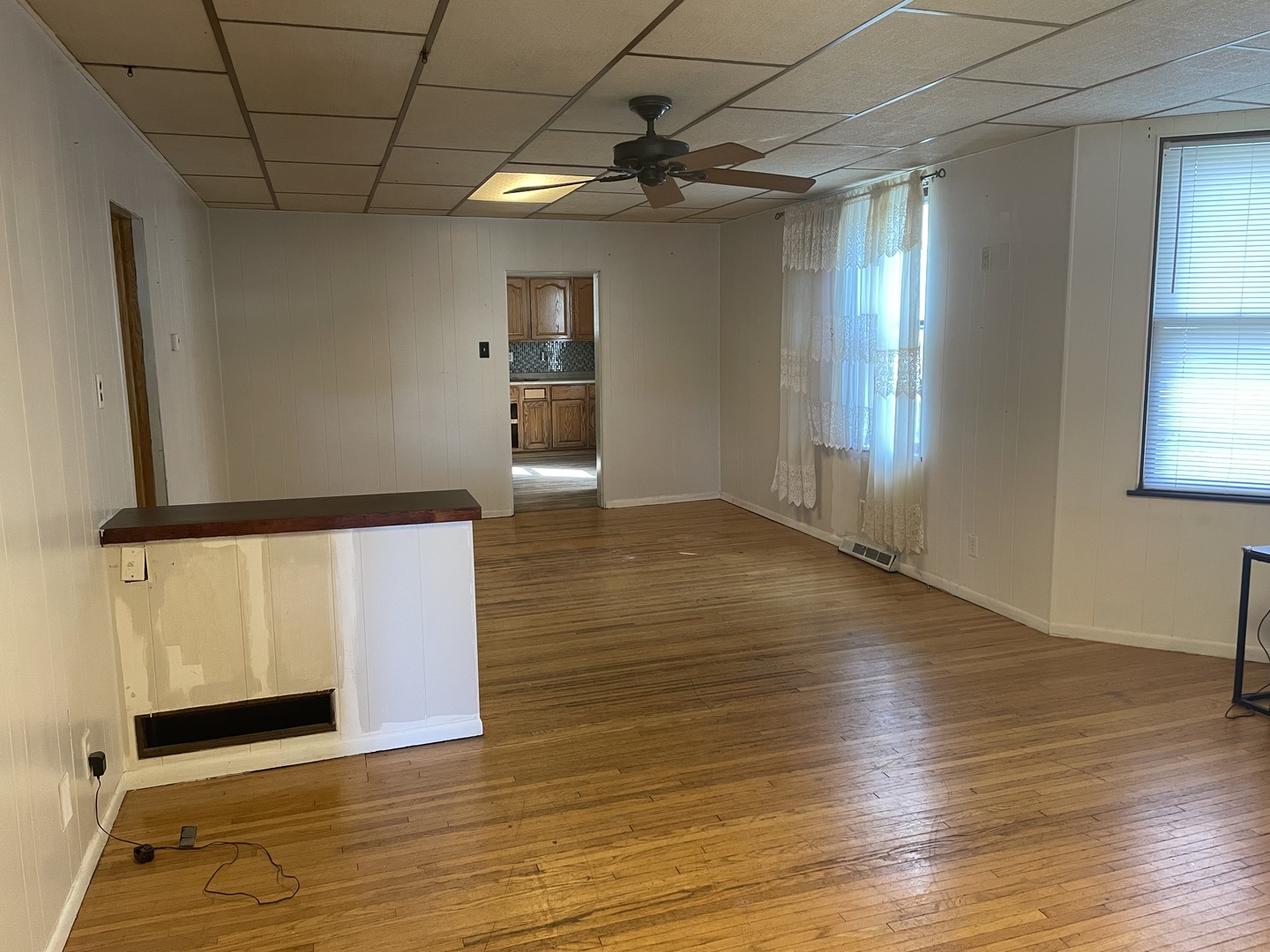 1407 Pulaski Street Peru, IL 61354 - Photo 8 of 9 an empty room with wooden floor and windows
