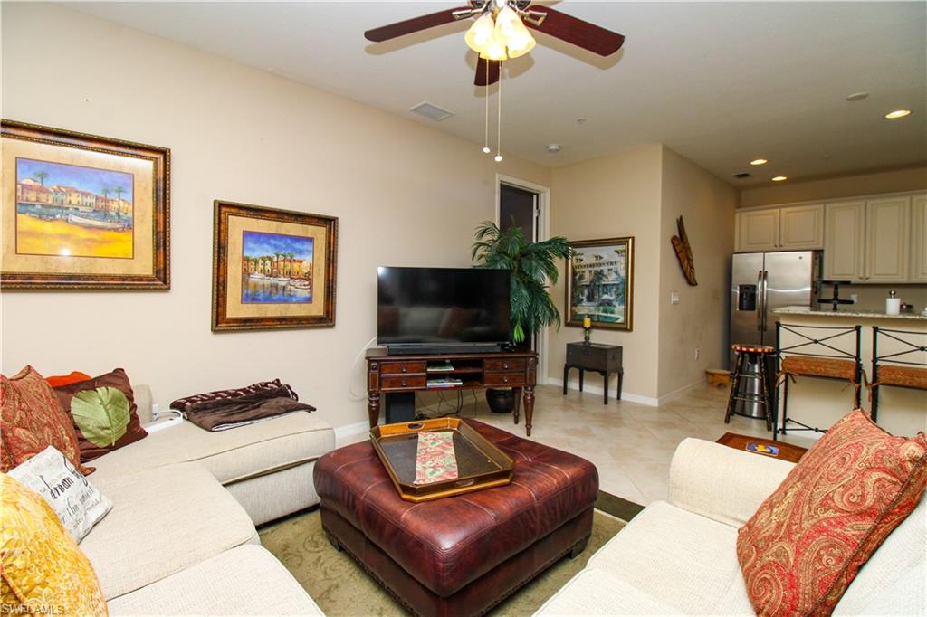 9054 Capistrano Street North, Unit 4003 Naples, FL 34113 - Photo 20 of 49 a living room with furniture and a flat screen tv