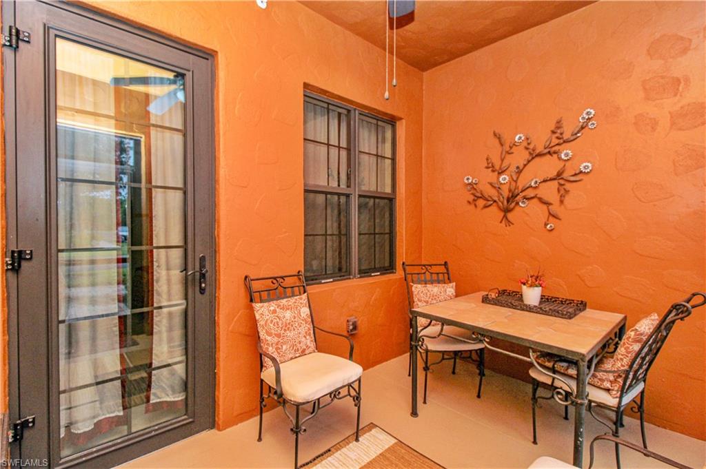 9054 Capistrano Street North, Unit 4003 Naples, FL 34113 - Photo 25 of 49 a balcony with table and chairs