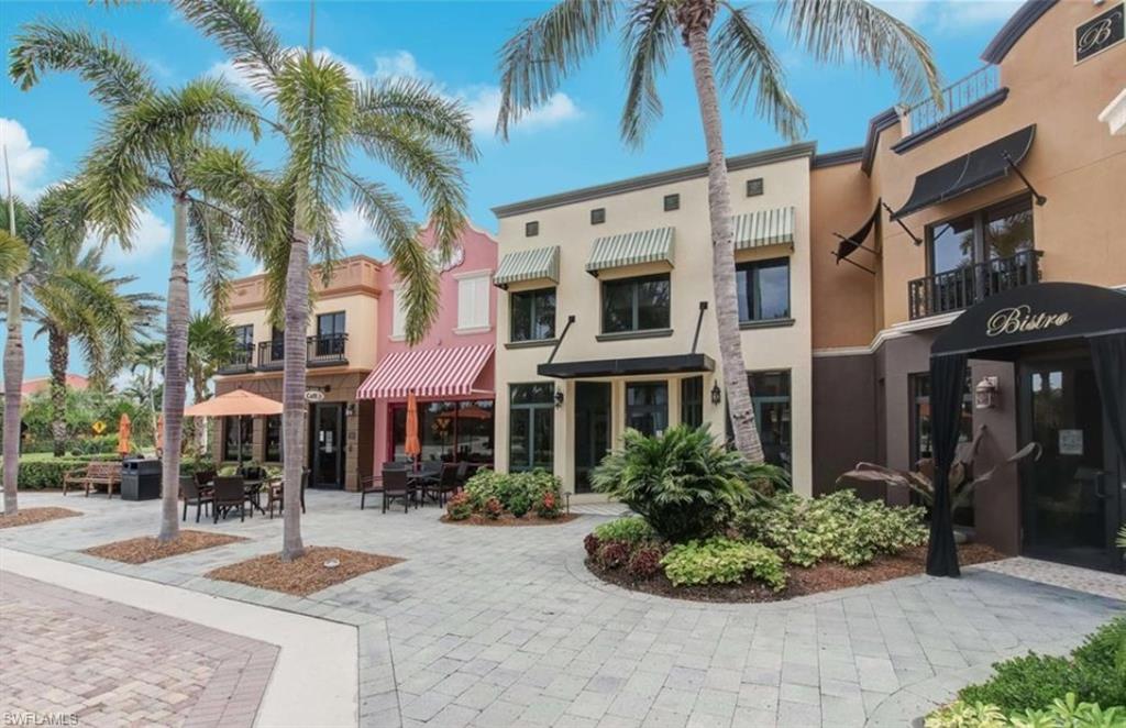 9054 Capistrano Street North, Unit 4003 Naples, FL 34113 - Photo 35 of 49 a front view of a building with garden