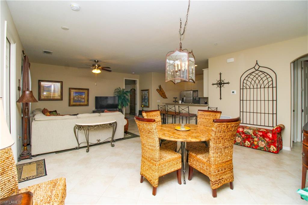 9054 Capistrano Street North, Unit 4003 Naples, FL 34113 - Photo 10 of 49 a living room with furniture a table and chairs