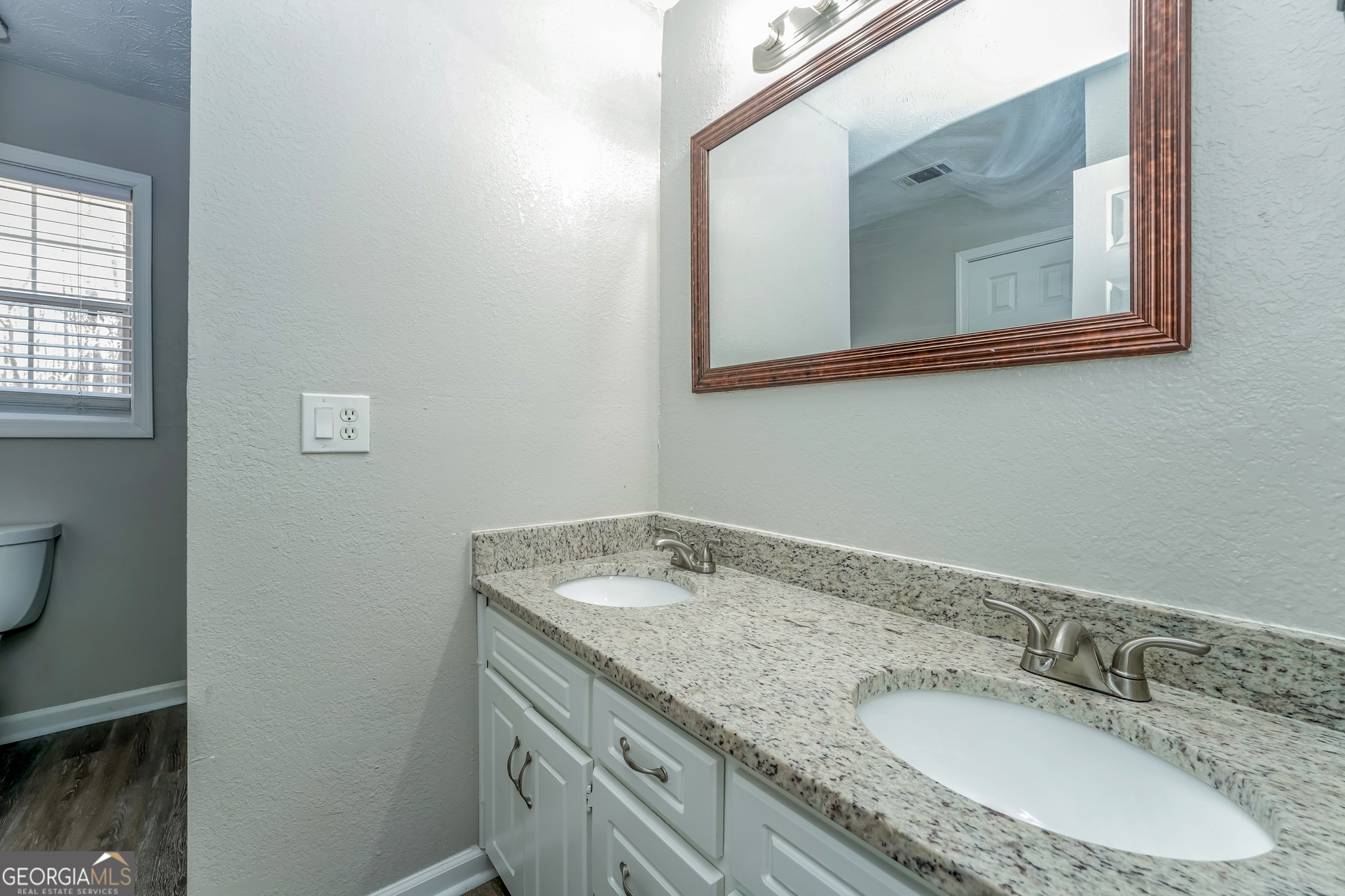 310 Alcovy Way Covington, GA 30014 - Photo 13 of 22 a bathroom with a granite countertop sink and a mirror