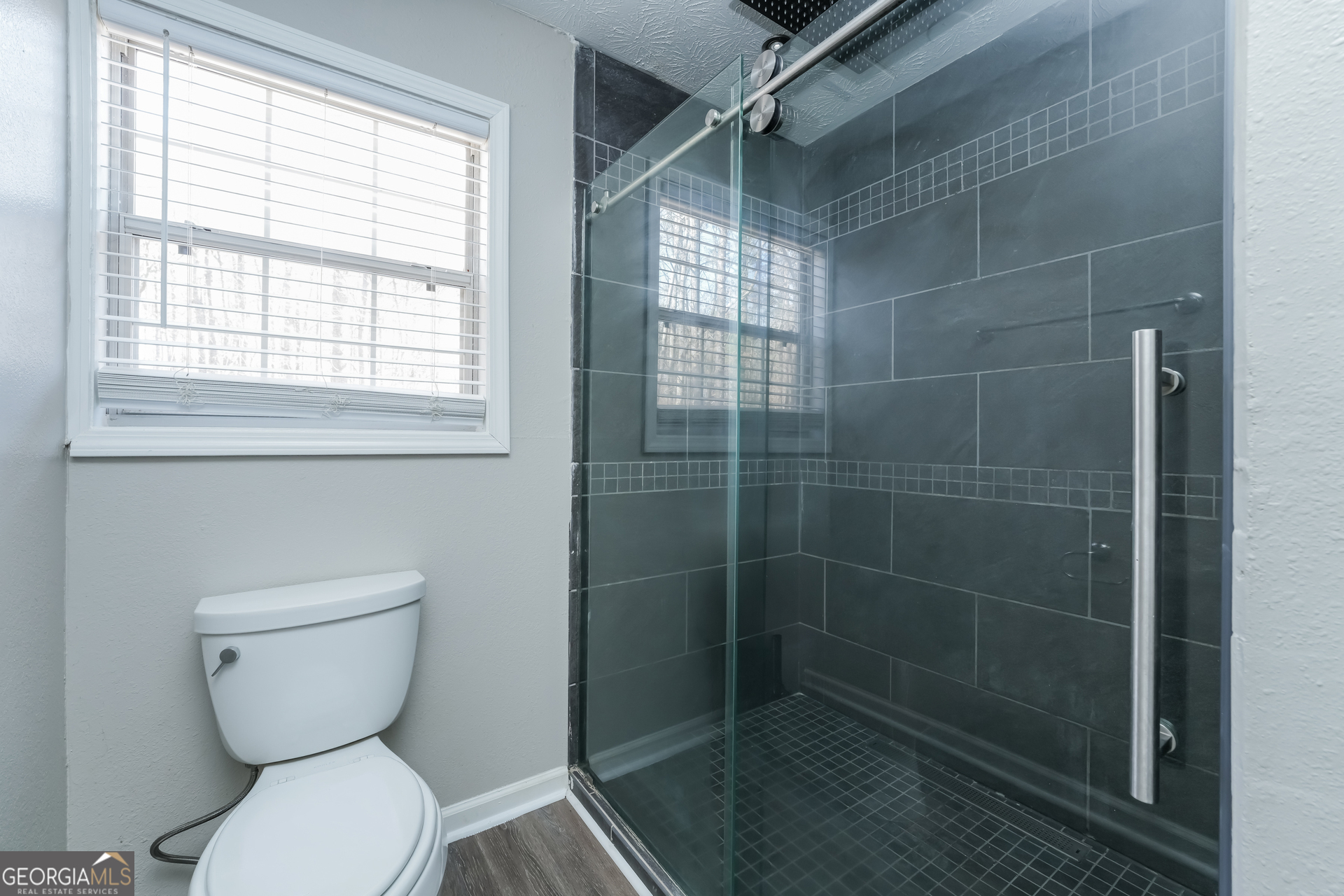 310 Alcovy Way Covington, GA 30014 - Photo 14 of 22 a bathroom with a toilet a sink and a shower