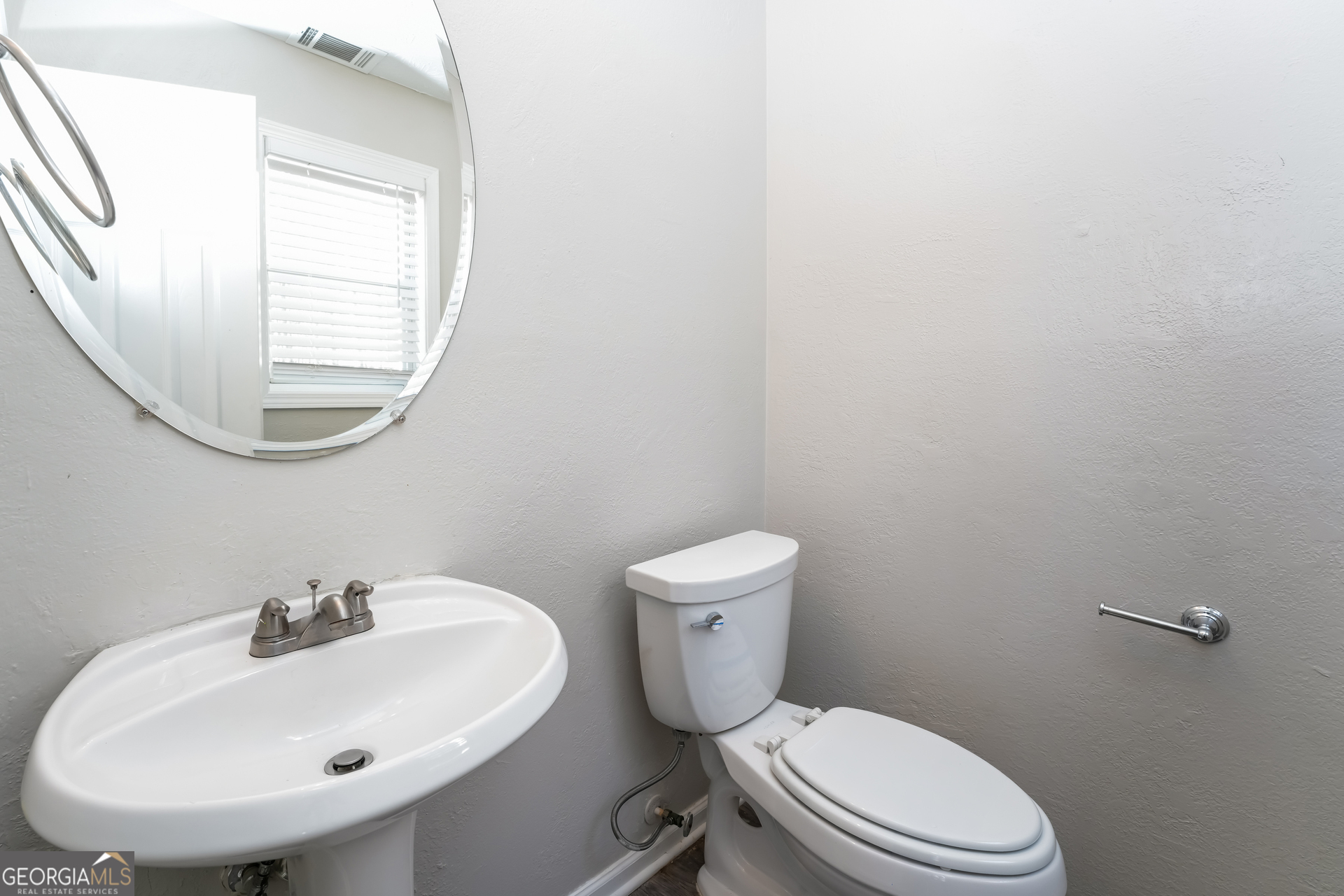 310 Alcovy Way Covington, GA 30014 - Photo 20 of 22 a white toilet sitting next to a bathroom sink