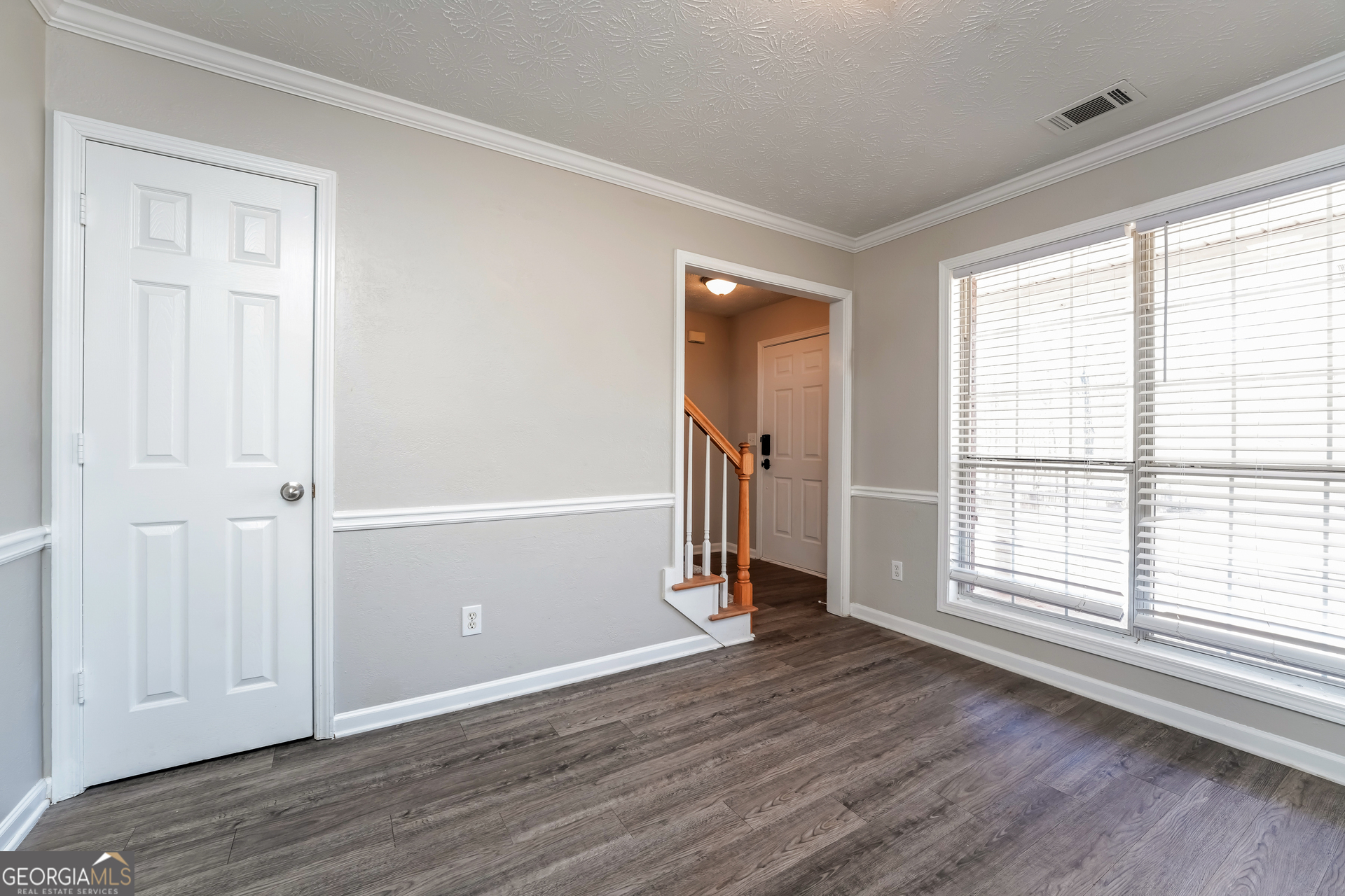 310 Alcovy Way Covington, GA 30014 - Photo 7 of 22 an empty room with wooden floor and windows