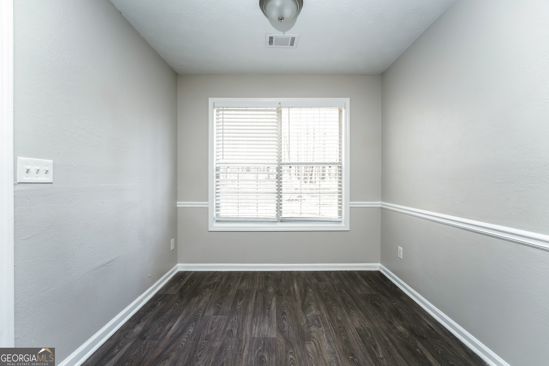 310 Alcovy Way Covington, GA 30014 - Photo 8 of 22 an empty room with wooden floor and windows