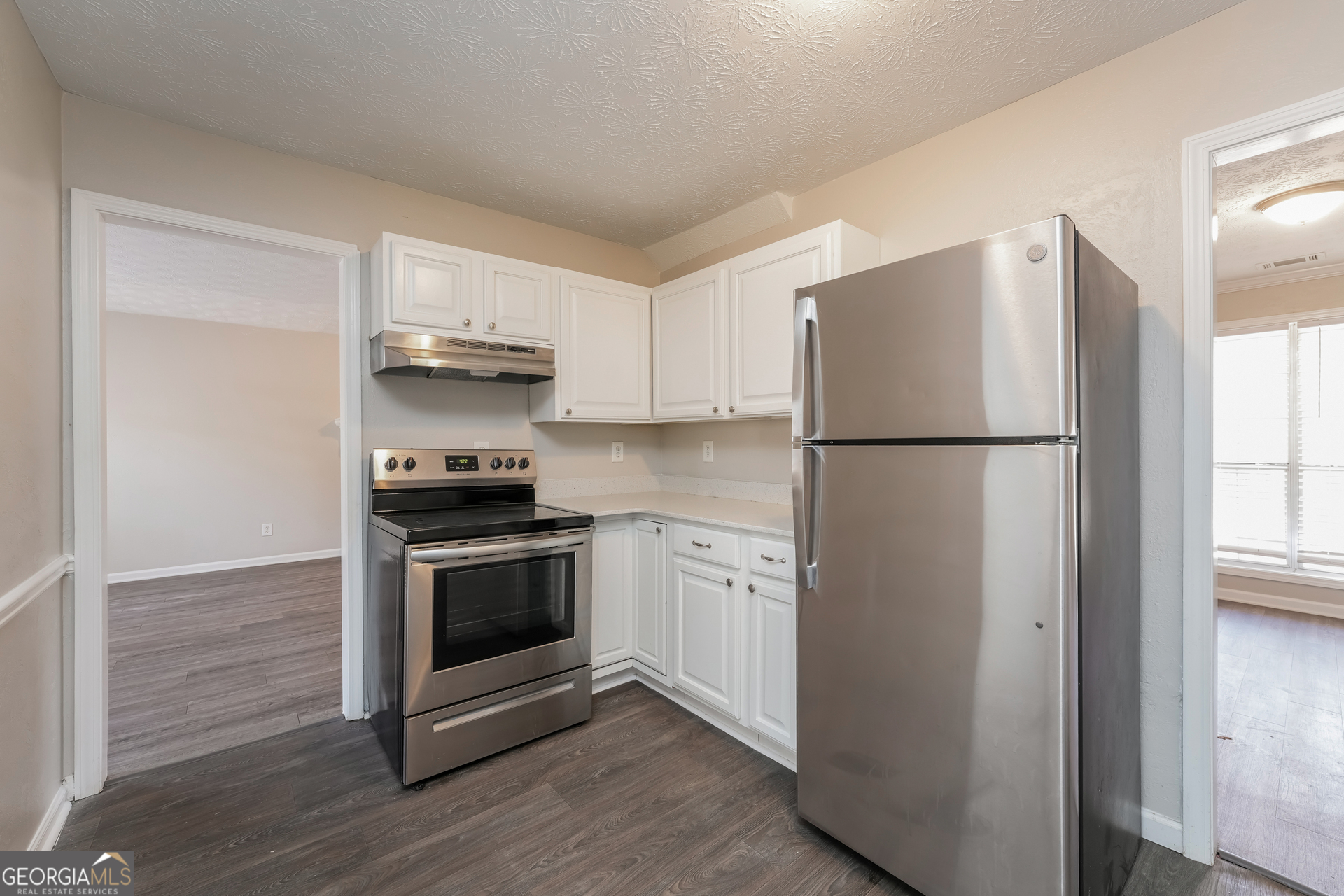 310 Alcovy Way Covington, GA 30014 - Photo 9 of 22 a kitchen with a refrigerator stove and cabinets