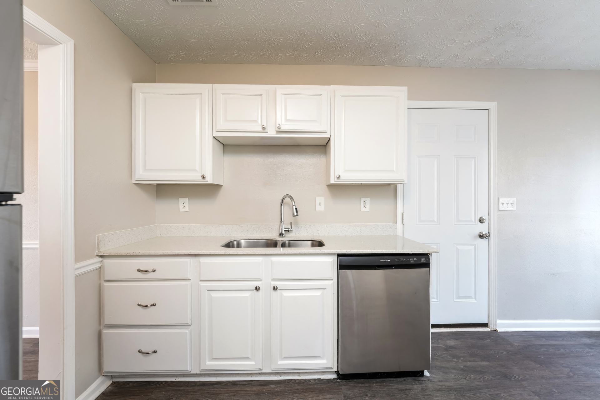 310 Alcovy Way Covington, GA 30014 - Photo 10 of 22 a kitchen with white cabinets and sink