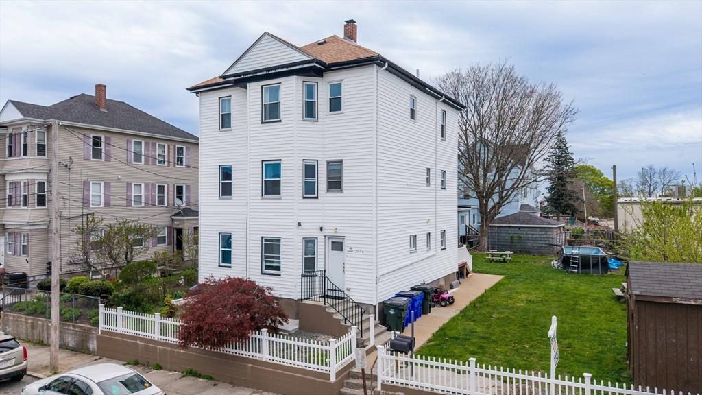 80 Lane Street, Unit 3 Fall River, MA 02721 - Photo 1 of 11 a view of a white house with a yard table and chairs