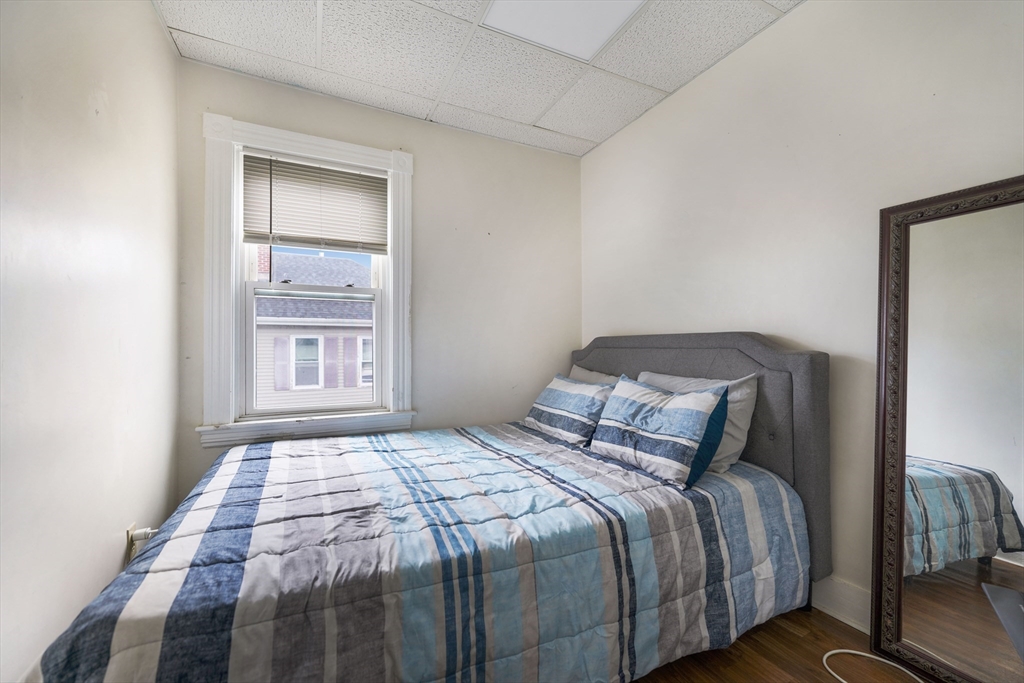 80 Lane Street, Unit 3 Fall River, MA 02721 - Photo 7 of 11 a bedroom with a bed and a window