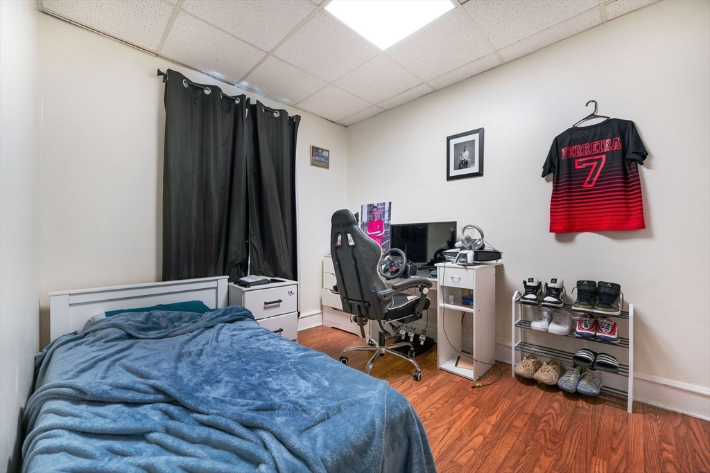 80 Lane Street, Unit 3 Fall River, MA 02721 - Photo 8 of 11 a bedroom with a bed and a desk