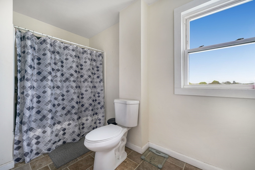 80 Lane Street, Unit 3 Fall River, MA 02721 - Photo 9 of 11 a bathroom with a toilet and a shower curtain