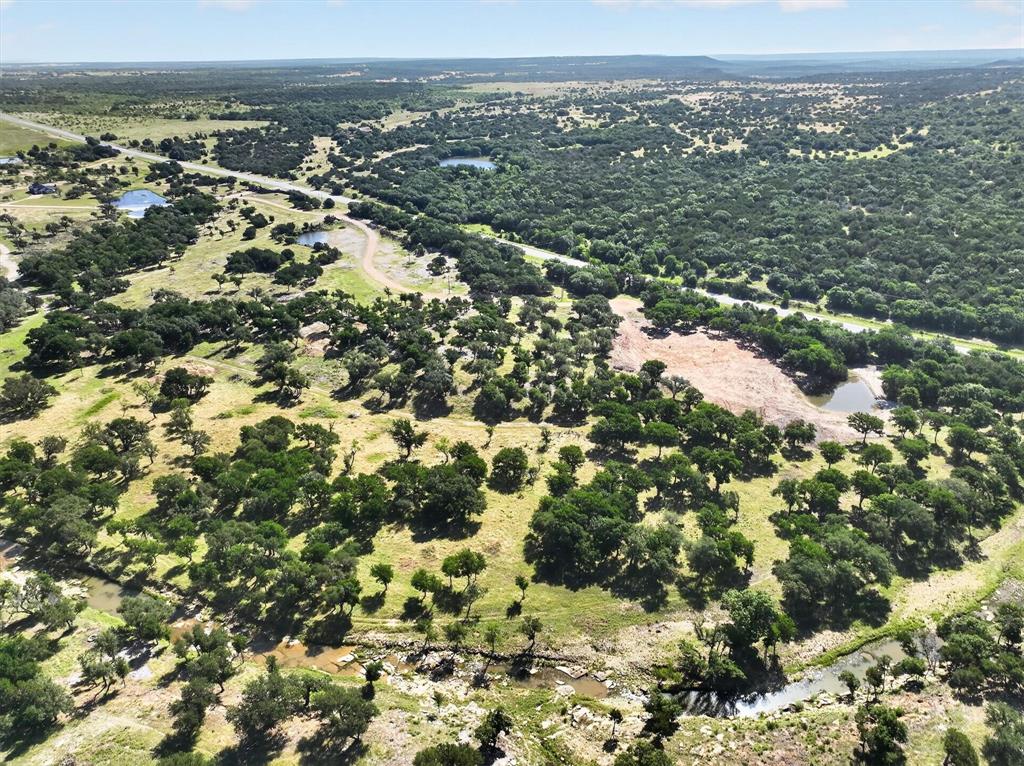 2 Armstrong Alley Strawn, TX 76475 - Photo 8 of 38 an aerial view of residential houses with outdoor space and trees