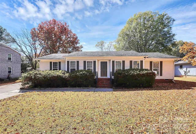 a view of house with yard and green space