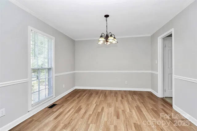 a view of a room with wooden floor water and a window