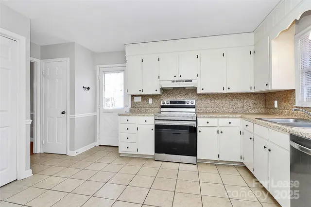 a kitchen with cabinets and appliances