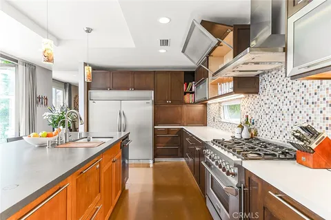 a view of a chairs and table in the patio and a backyard