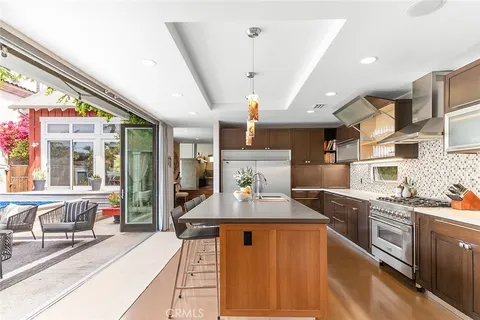 a living room with furniture floor to ceiling window and a flat screen tv