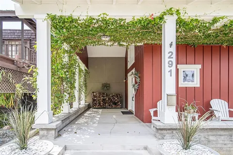 a bedroom with a bed and painting on the wall