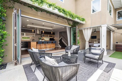 a view of a house with swimming pool and sitting area