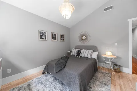 a spacious bedroom with a bed and a flat screen tv