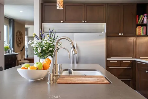 a kitchen with stainless steel appliances granite countertop a sink a stove and a refrigerator