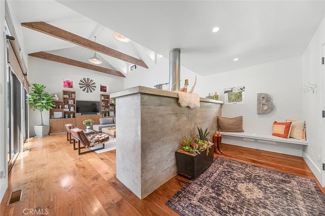 a kitchen with stainless steel appliances granite countertop a sink and a refrigerator