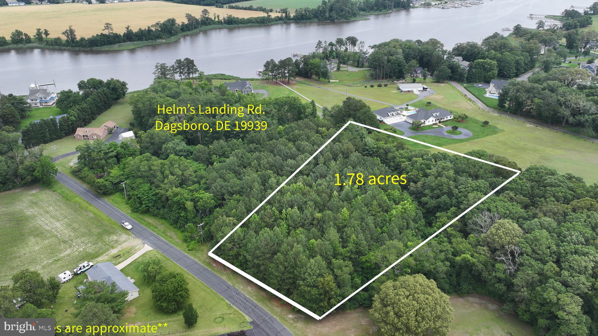an aerial view of a residential houses with outdoor space and lake view