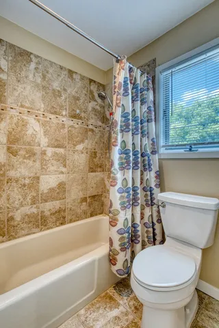 a spacious bathroom with a granite countertop sink mirror and vanity