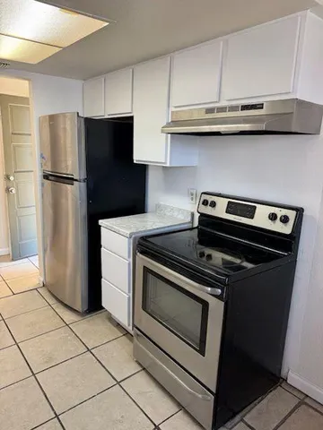 a kitchen with appliances and cabinets