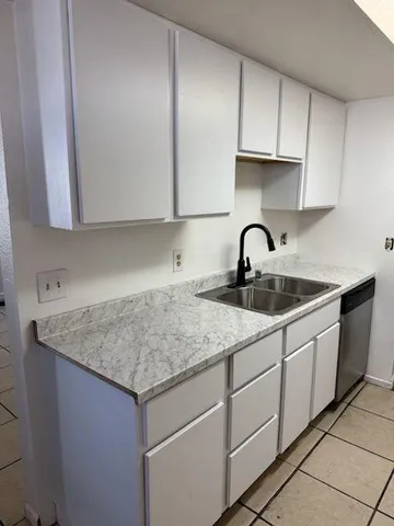 a kitchen with a sink and cabinets