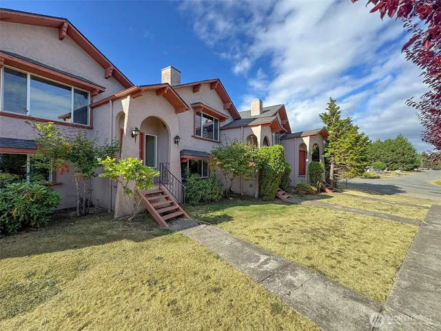 a front view of a house with a garden