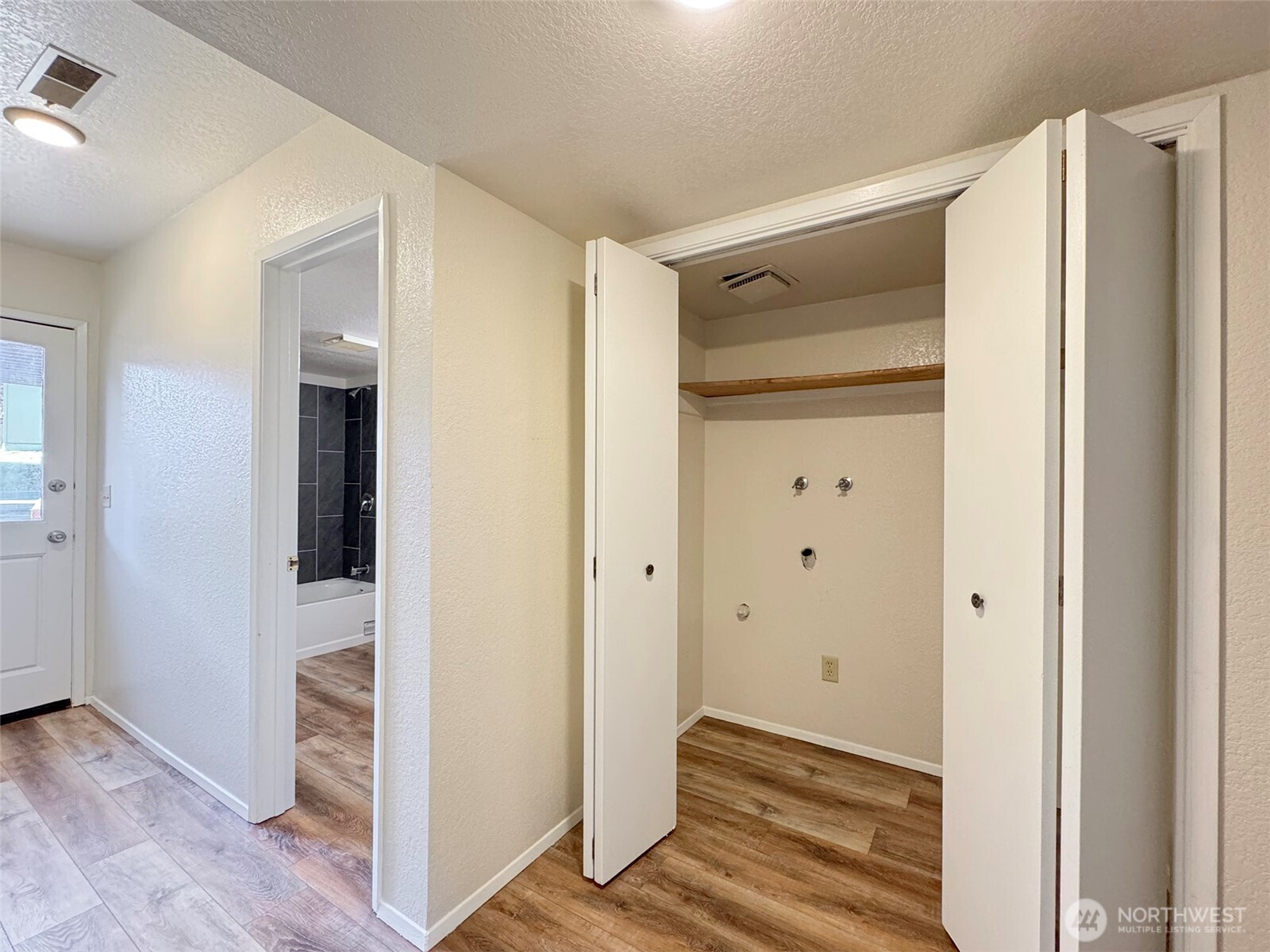 1212 Craig Avenue, Unit 3 Port Angeles, WA 98362 - Photo 23 of 38 a view of a hallway with wooden floor and closet area