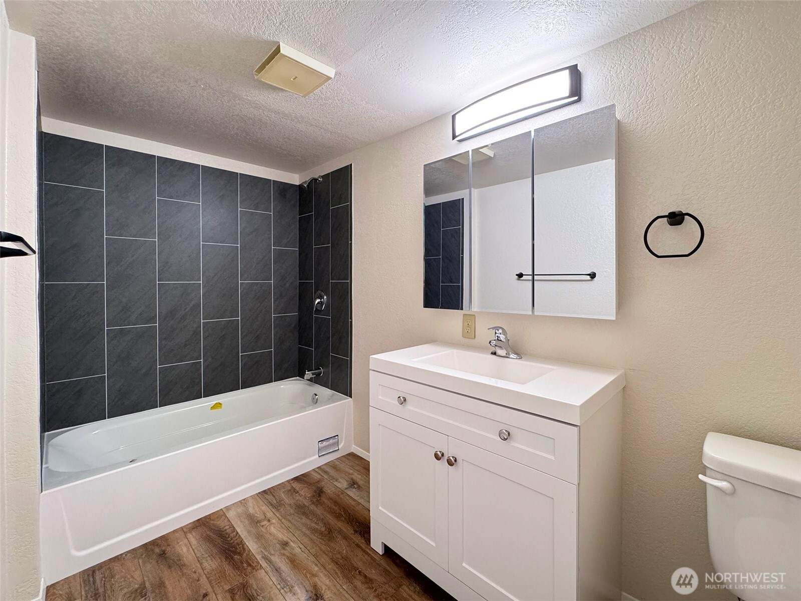 1212 Craig Avenue, Unit 3 Port Angeles, WA 98362 - Photo 24 of 38 a bathroom with a sink toilet vanity and bathtub