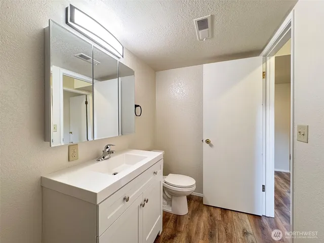a view of a house with a yard and large tree