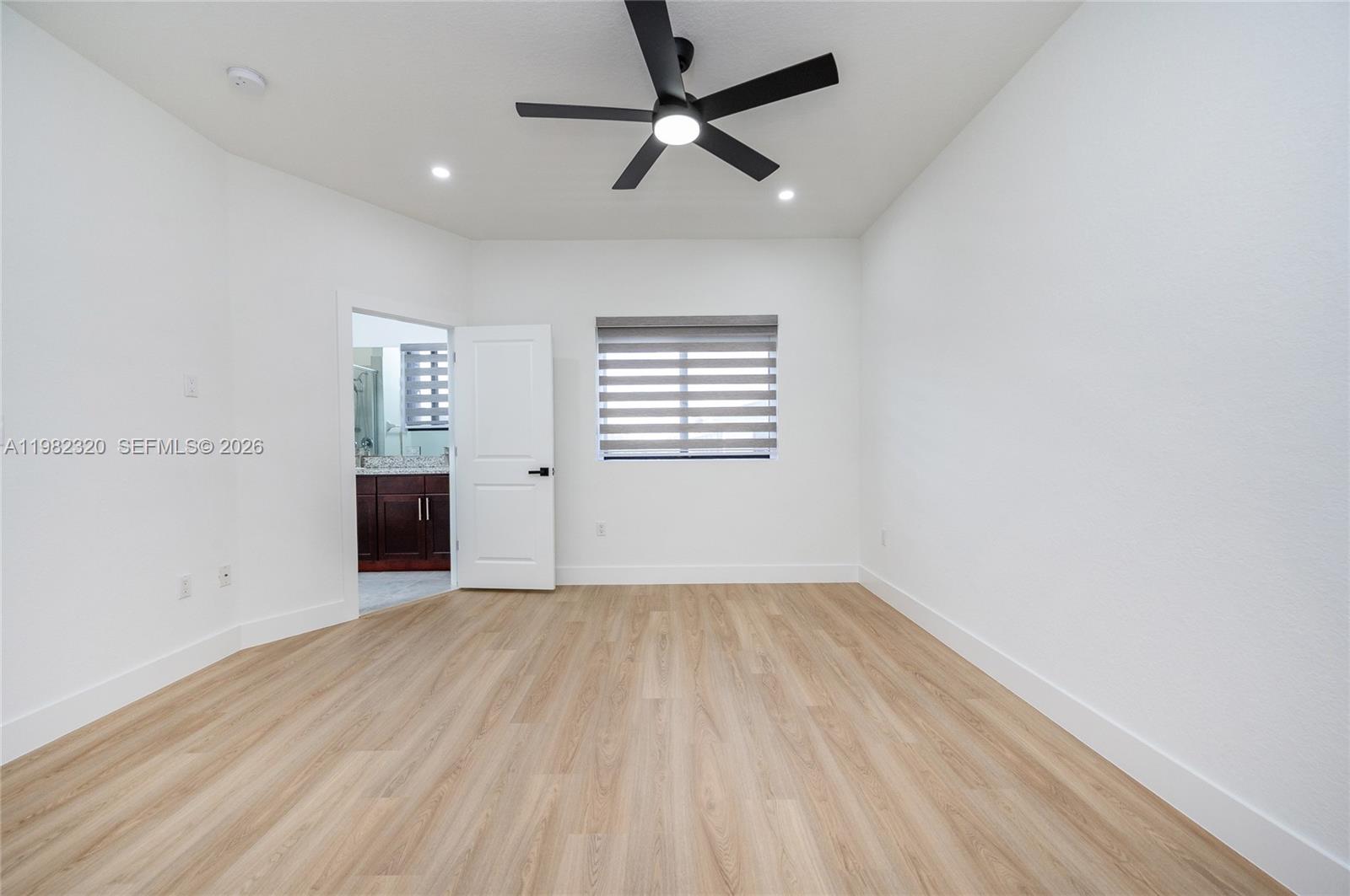13353 Southwest 250th Terrace Homestead, FL 33032 - Photo 19 of 25 an empty room with windows and fan