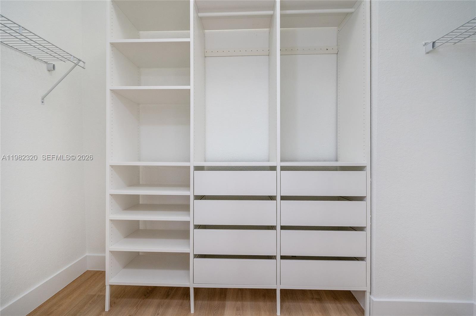 13353 Southwest 250th Terrace Homestead, FL 33032 - Photo 21 of 25 a view of walk in closet with empty racks