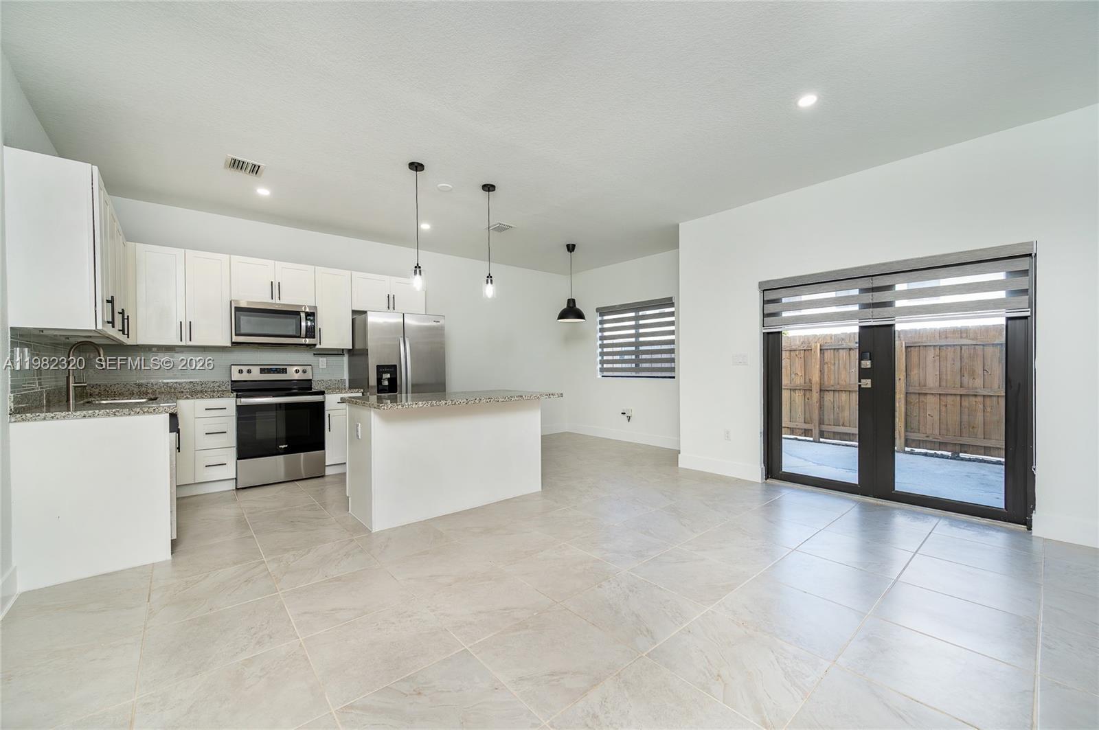 13353 Southwest 250th Terrace Homestead, FL 33032 - Photo 5 of 25 a large kitchen with cabinets and stainless steel appliances
