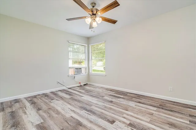a view of a room with a window and a ceiling fan