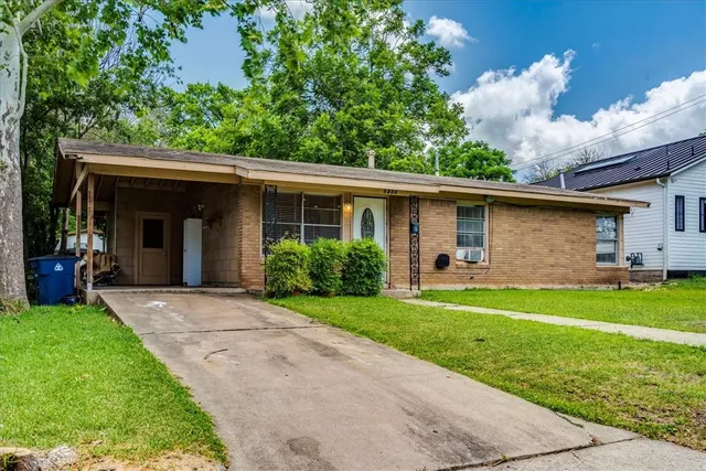 a view of a back yard of the house with a yard
