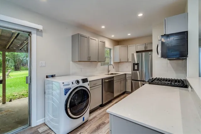 a kitchen with a refrigerator and a stove top oven