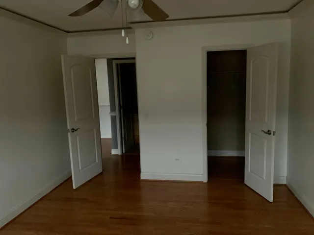 an empty room with wooden floor and closet