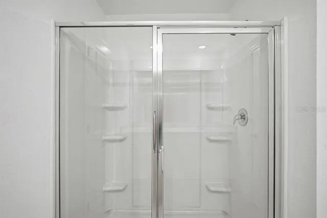 a bathroom with a glass shower door